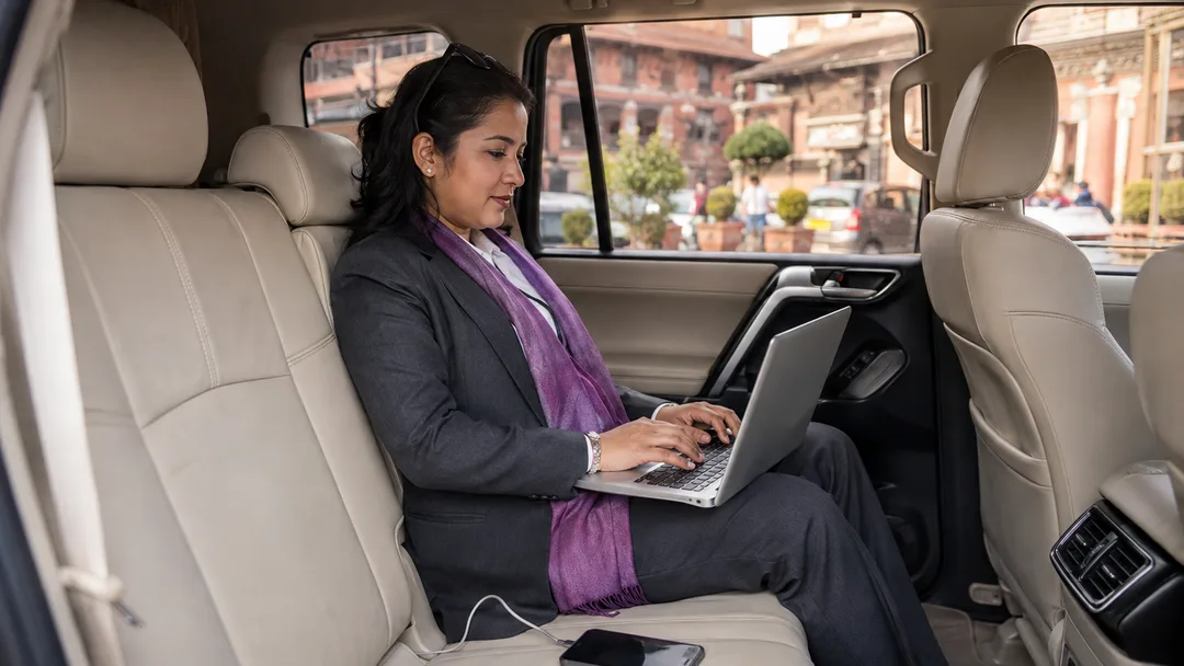 A business passenger working comfortably in a premium SUV